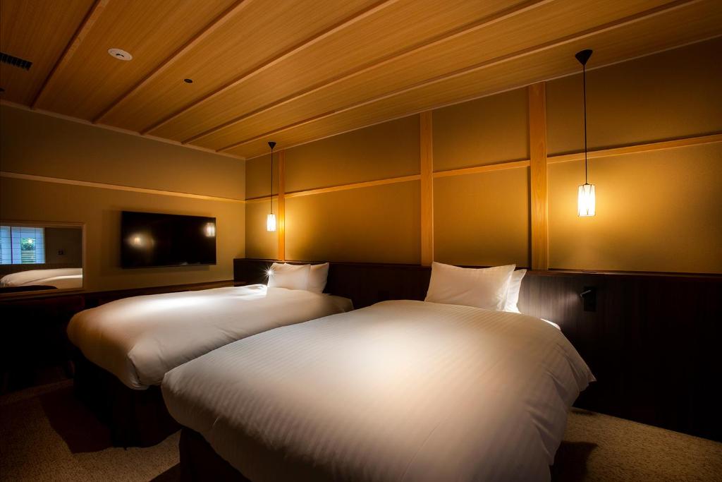 Postel nebo postele na pokoji v ubytování Hotel Utano Kyoto Besho