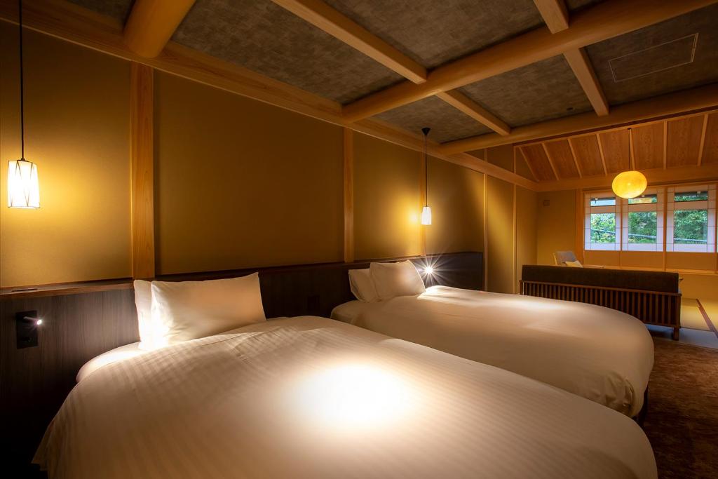 Postel nebo postele na pokoji v ubytování Hotel Utano Kyoto Besho