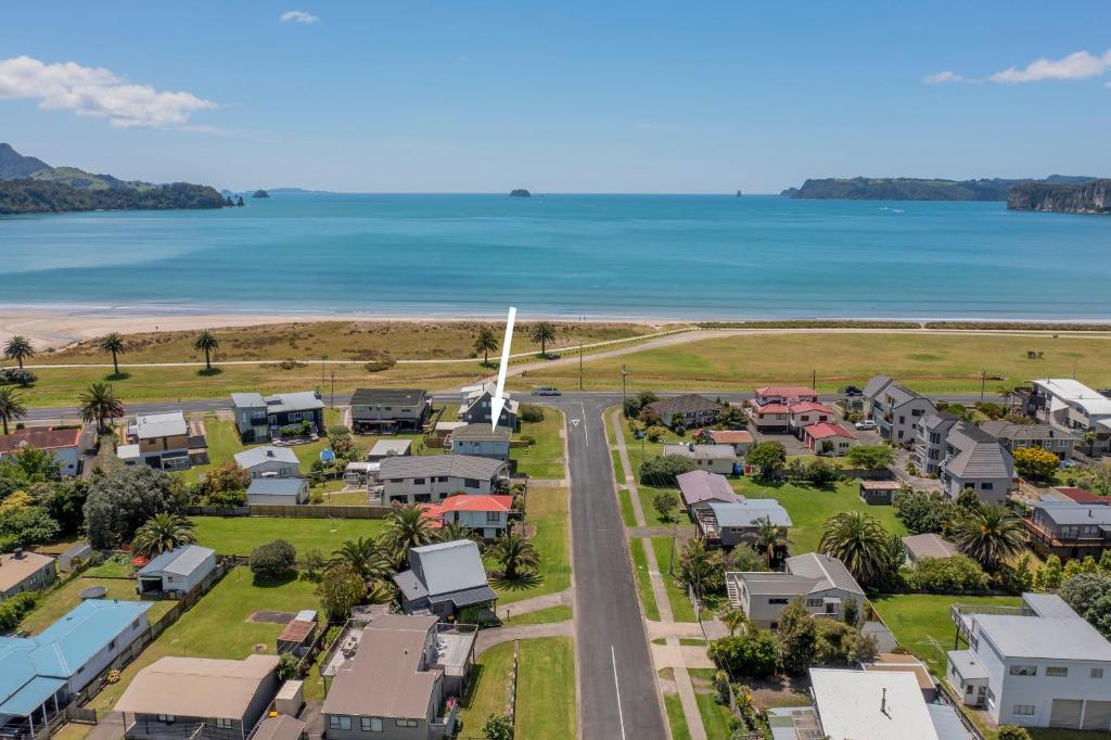 an aerial view of a small town next to the beach at Across the Road to the Beach - Beach House in Whitianga