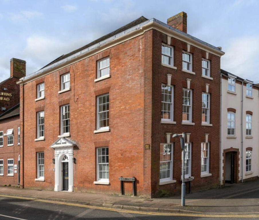 a red brick building on the corner of a street at The Byron Suite in Lichfield