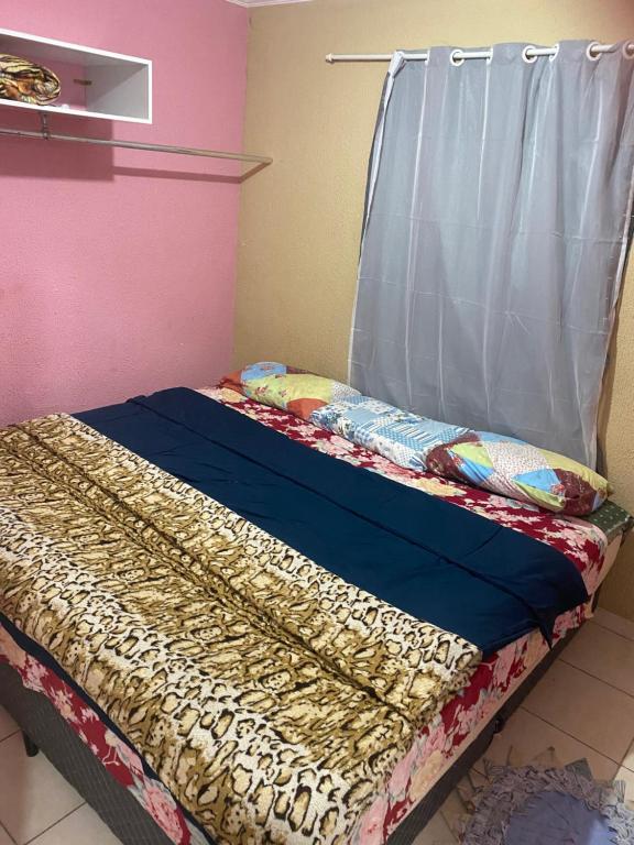 a bed with a canopy in a room at Hostel Gonzales in Votorantim