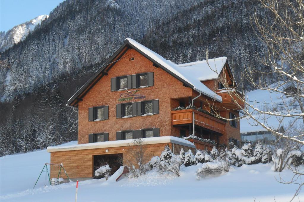 a large building with snow on the roof at Haus Brügga in Brand