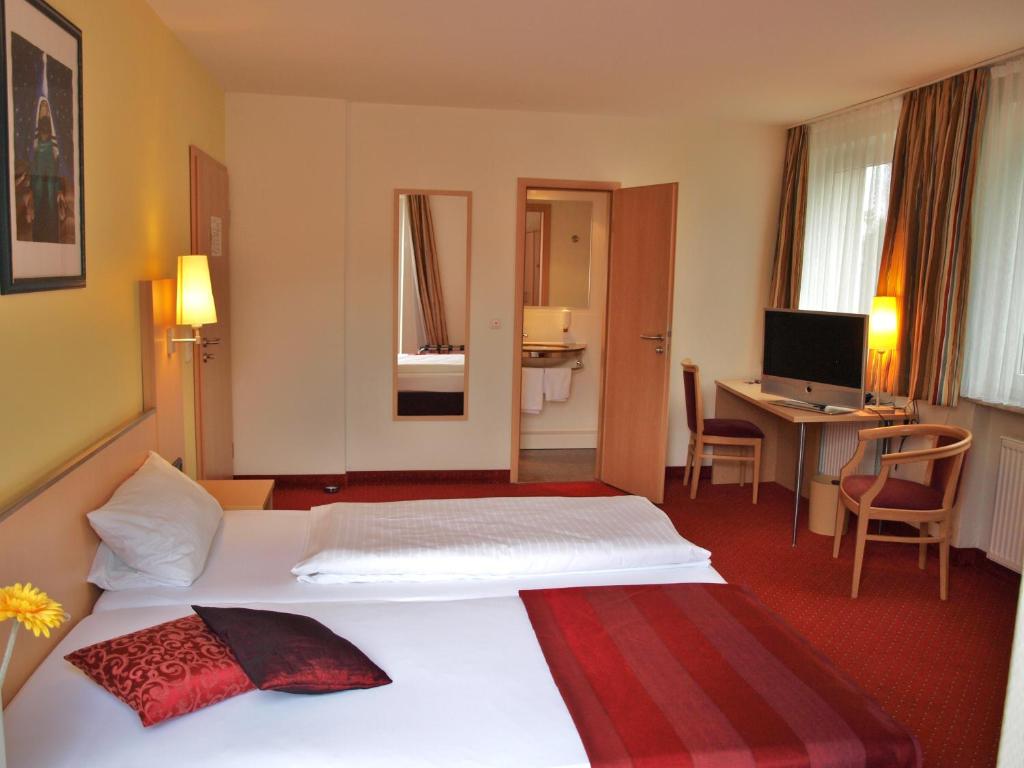 Postel nebo postele na pokoji v ubytování Hotel An der Eiche