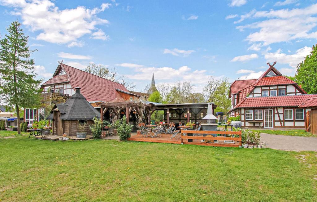 a large house with a large yard in front of it at Ferienwohnung Südmüritz in Vipperow