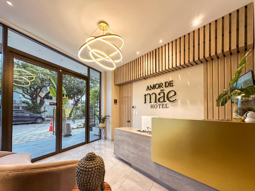 a lobby of a mace hotel with a large window at Hotel Amor de Mae in Santa Marta