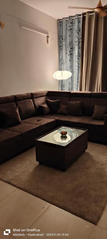 ein Wohnzimmer mit einem Sofa und einem Couchtisch in der Unterkunft The Cozy Nest 1 in Hyderabad