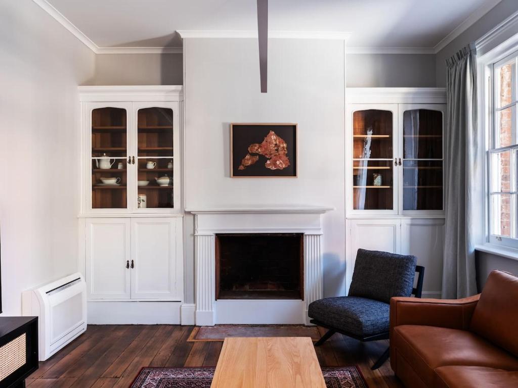 a living room with a couch and a fireplace at The Macquarie in Hobart