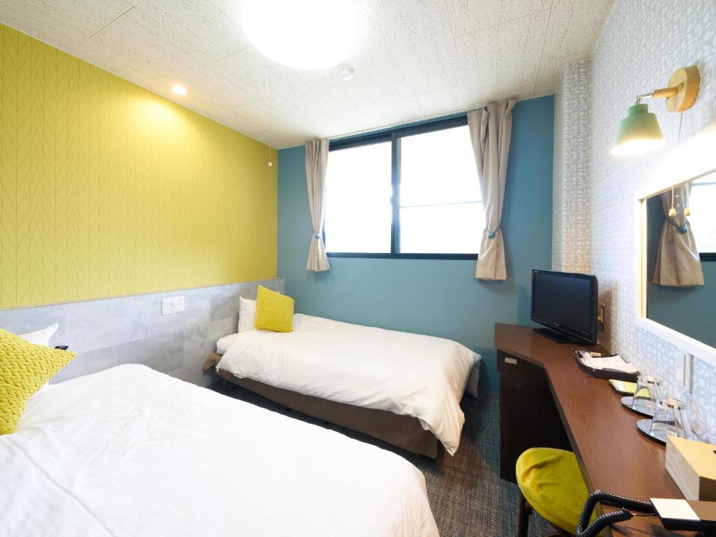Postel nebo postele na pokoji v ubytování Hotel Village