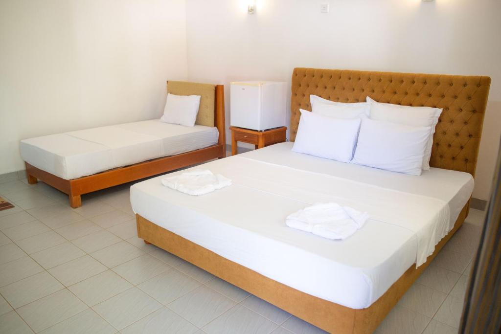Postel nebo postele na pokoji v ubytování The Jungle Pearl Hotel