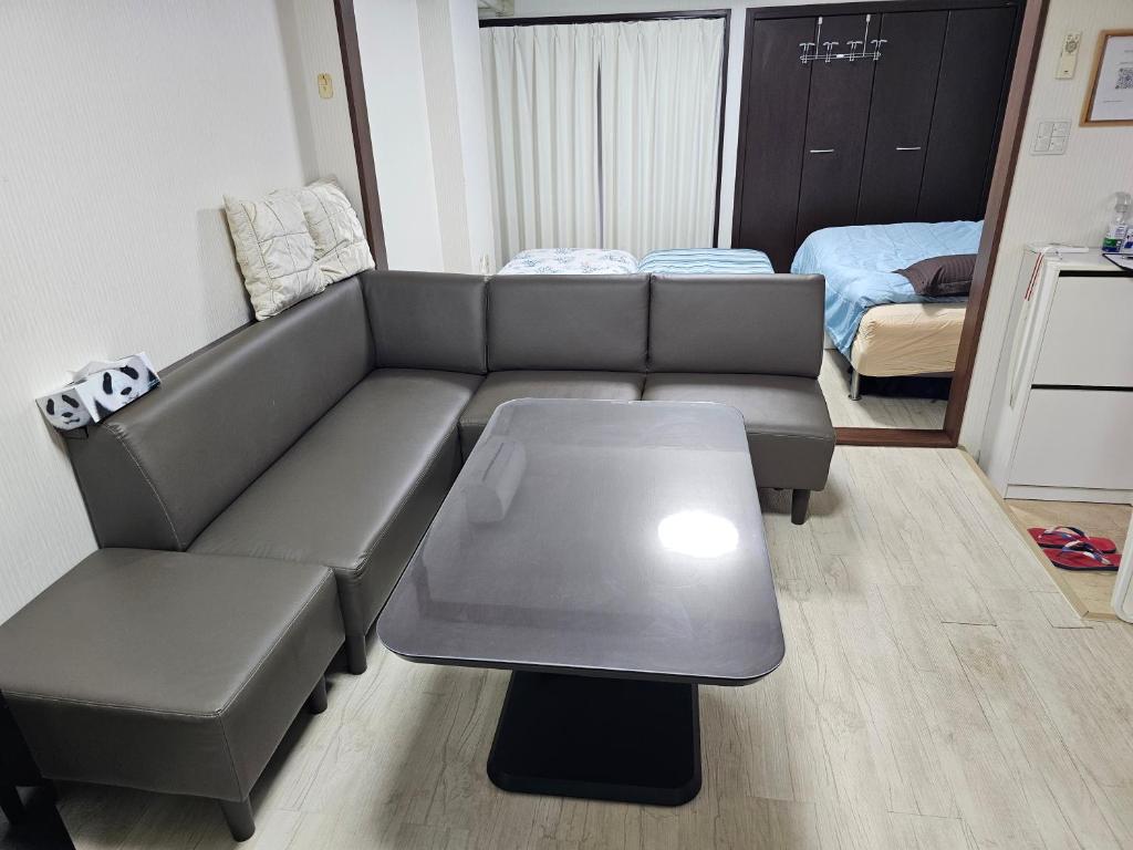 a living room with a couch and a table at YOYOGi STAY in Tokyo