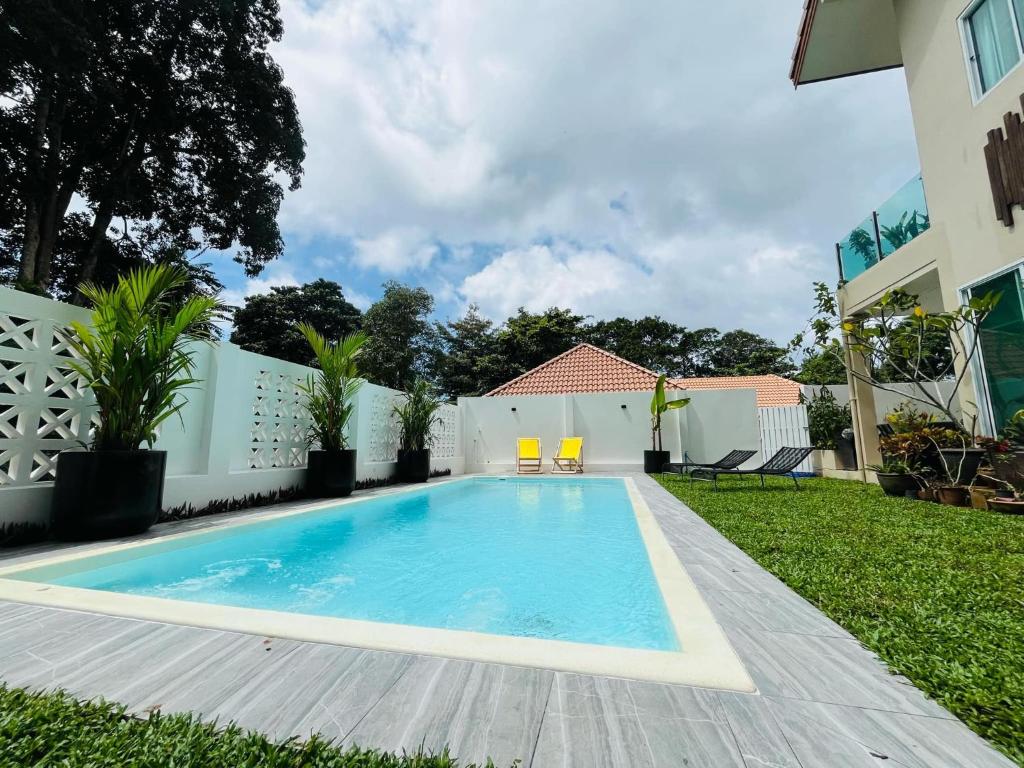 a swimming pool in the backyard of a house at POOL VILLA TIPPAWAN Koh Chang in Ko Chang