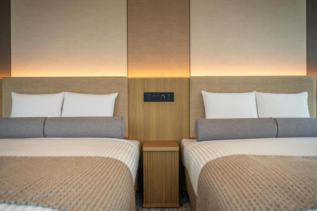 Postel nebo postele na pokoji v ubytování ART HOTEL Nippori Lungwood