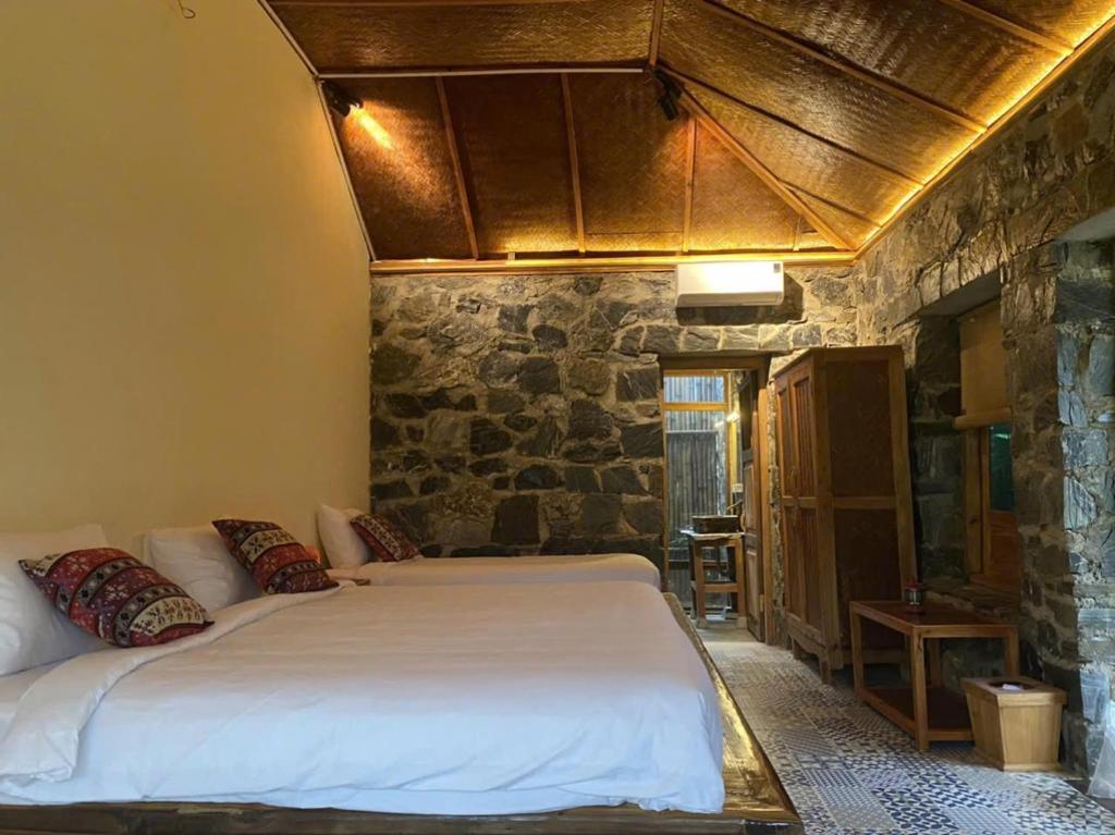 Giường trong phòng chung tại Ha Giang Ecolodge