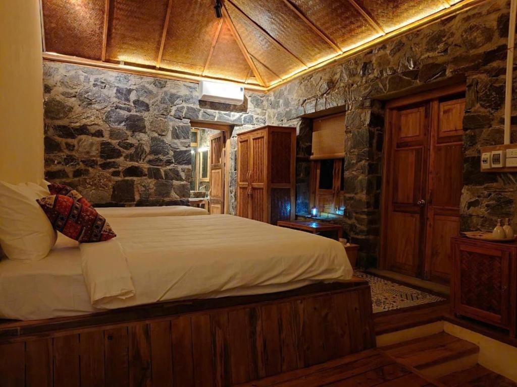 Giường trong phòng chung tại Ha Giang Ecolodge