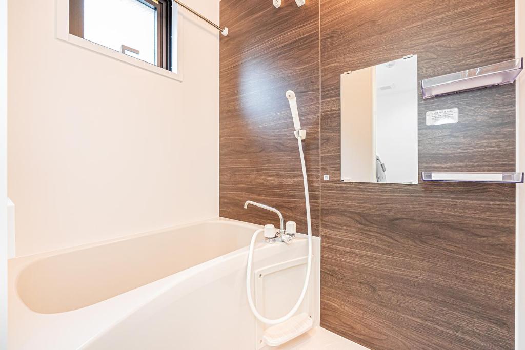 a bathroom with a bath tub and a sink at New-built APT at Asakusa-Skytree area with Tranquil block in Tokyo