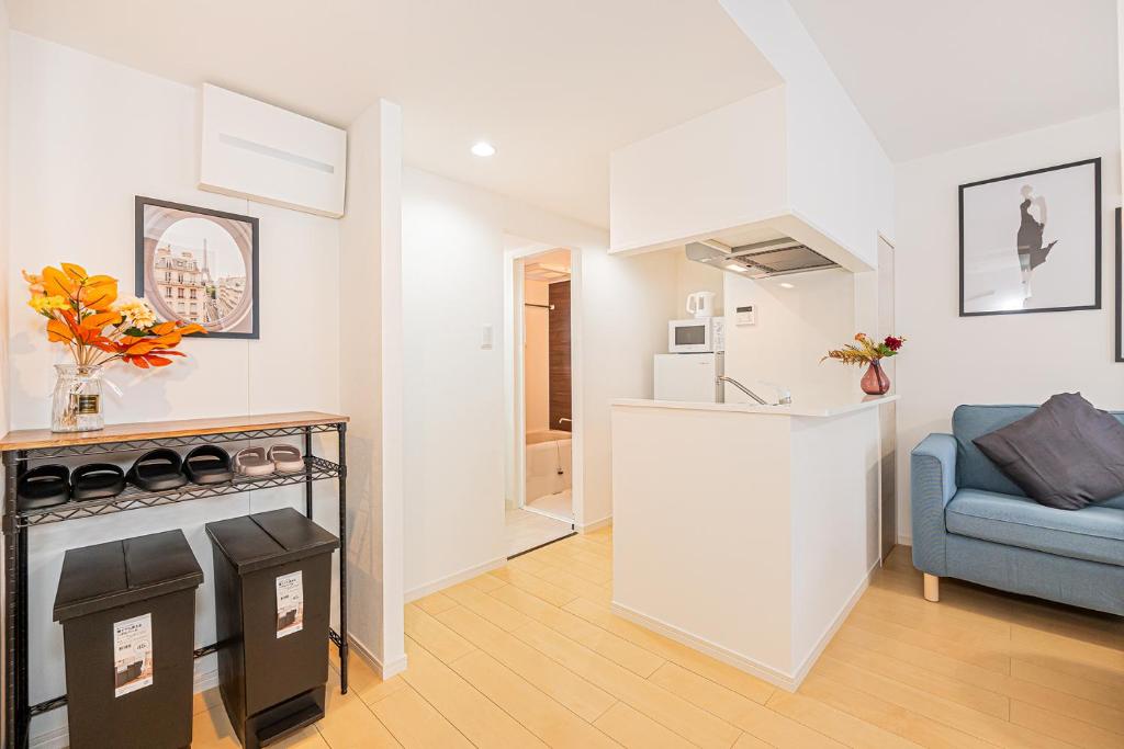 a kitchen and living room with a couch and a stove at New-built APT at Asakusa-Skytree area with Tranquil block in Tokyo