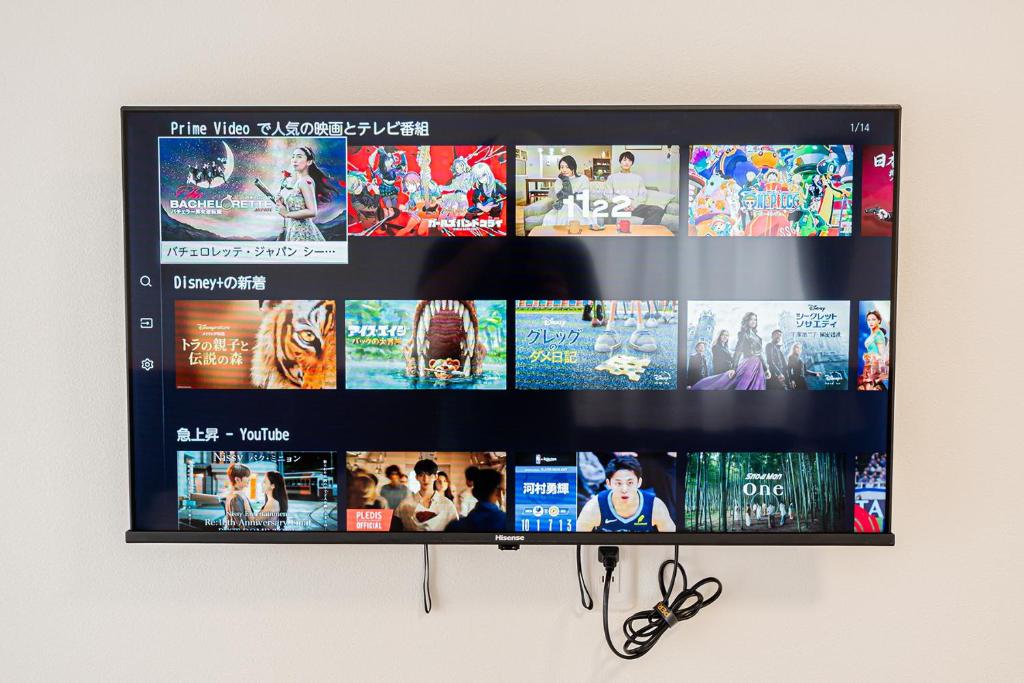 a flat screen tv hanging on a wall at New-built APT at Asakusa-Skytree area with Tranquil block in Tokyo