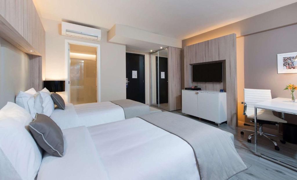 Cama ou camas em um quarto em Radisson Blu Belo Horizonte Savassi