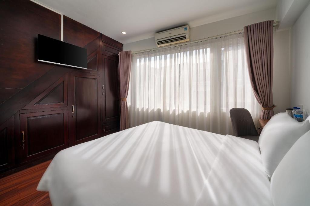 Voodi või voodid majutusasutuse Charlie House Hanoi toas