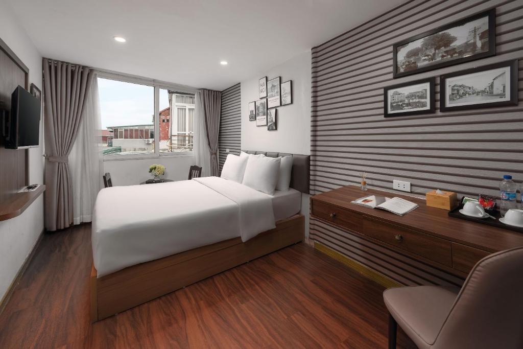 Voodi või voodid majutusasutuse Charlie House Hanoi toas