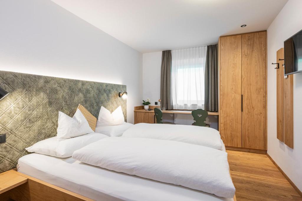 Postel nebo postele na pokoji v ubytování Gasthof Albergo Dolomiten