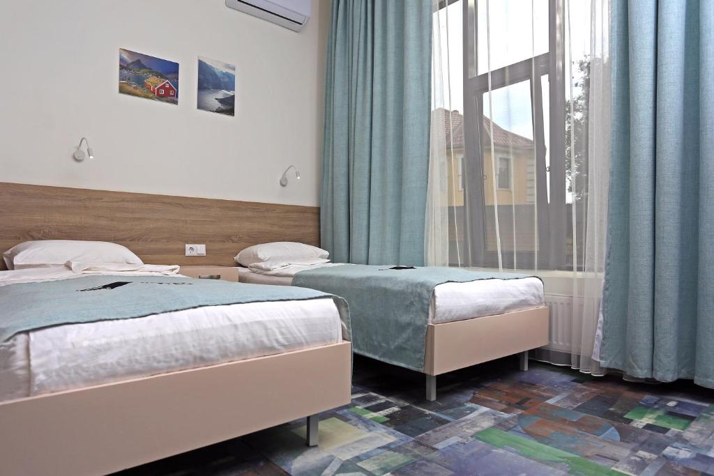 Postel nebo postele na pokoji v ubytování Scandi Hotel