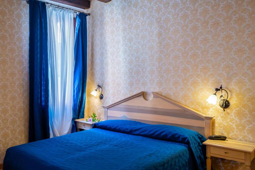 Voodi või voodid majutusasutuse Hotel Tintoretto toas