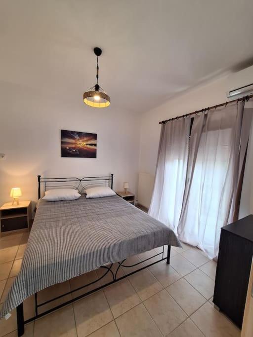 a bedroom with a bed and a tv in a room at D and D Home Alonissos in Alonnisos