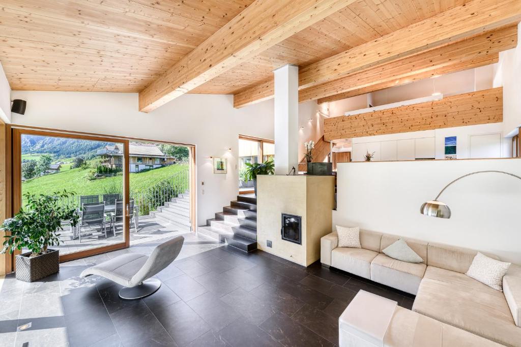 a living room with a couch and a fireplace at Panorama Chalet Bellavista in Brand