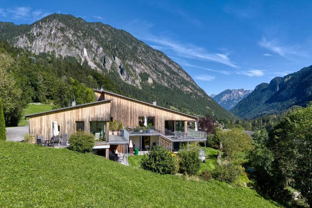 a house on a hill with mountains in the background at Panorama Chalet Bellavista in Brand
