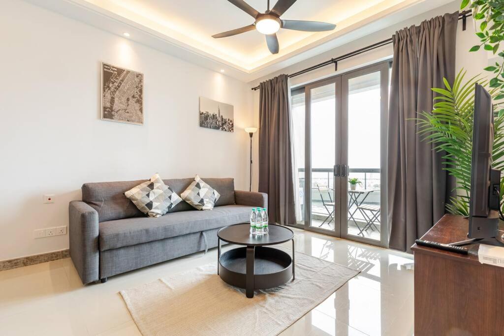 a living room with a couch and a table at SeaView R&F 4pax-1BR 10mis to CIQ JBSentral CitySquare in Johor Bahru