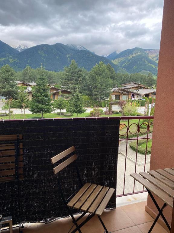 a bench on a balcony with a view of mountains at Pirin Golf private studio in Razlog