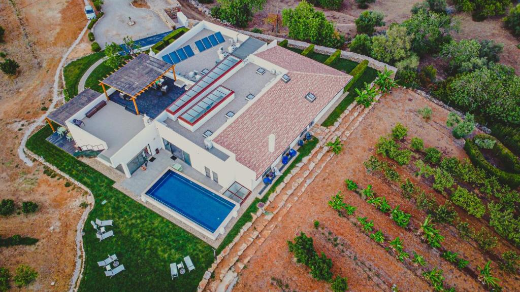 an overhead view of a house with a swimming pool at Mercedes Country House in Faro