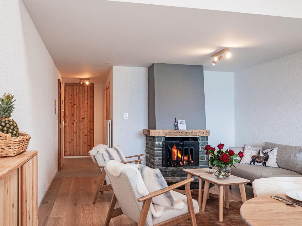 a living room with a couch and a fireplace at Apartment Haut de Cry 16 by Interhome in Nendaz