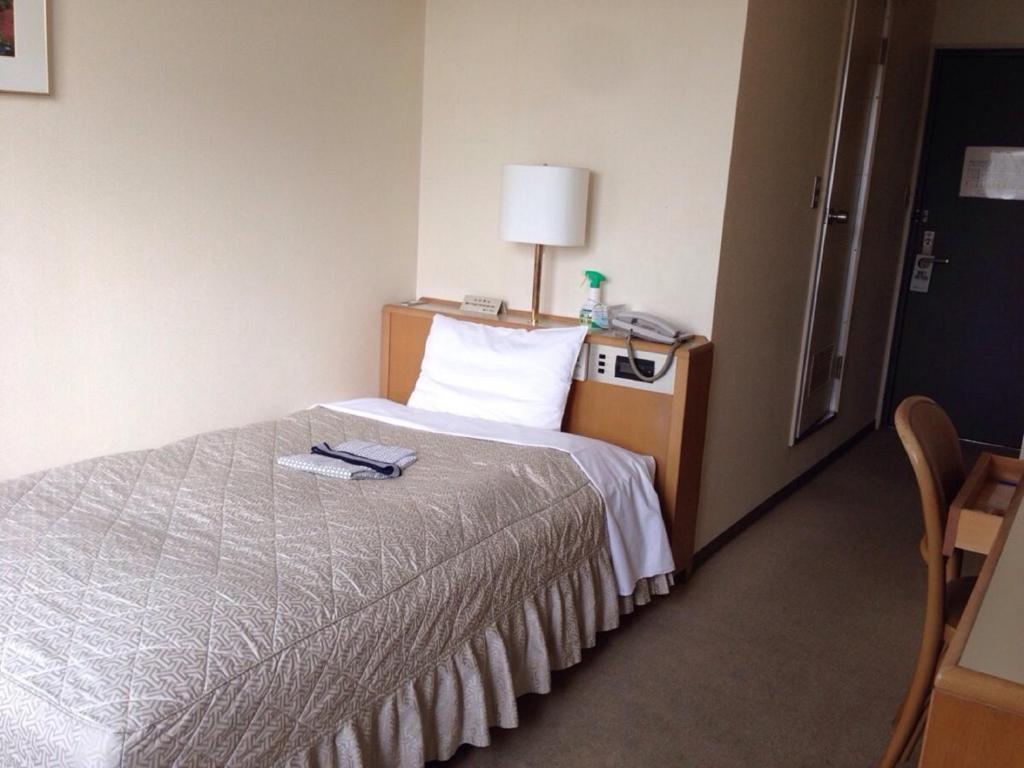 Postel nebo postele na pokoji v ubytování Seto Park Hotel