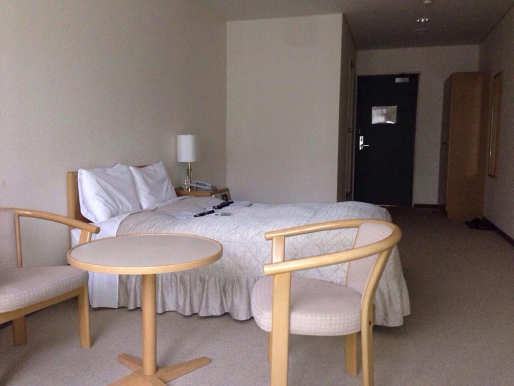 Postel nebo postele na pokoji v ubytování Seto Park Hotel