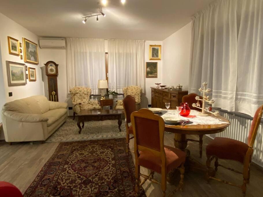 a living room with a table and a couch at B&B casa Orsingher a 2 passi da Belluno in Trichiana