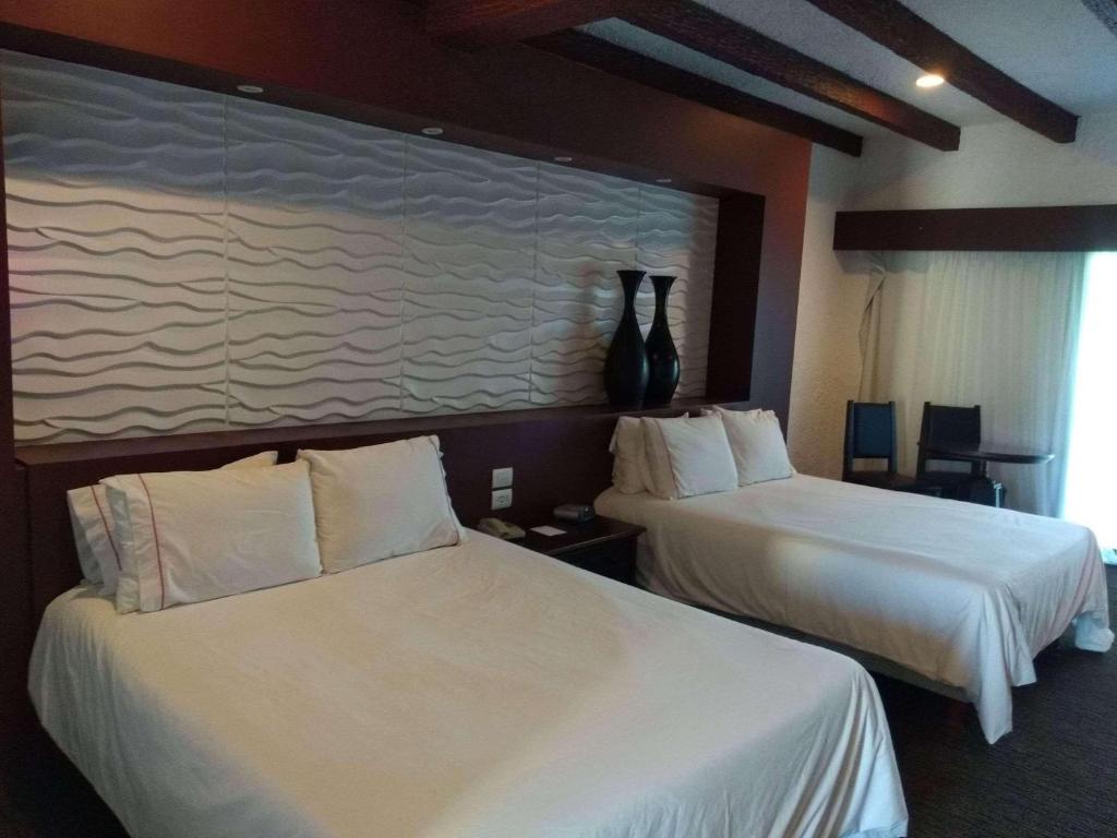 Postel nebo postele na pokoji v ubytování Radisson Hotel Tapatio Guadalajara Aeropuerto