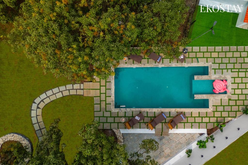 an overhead view of a swimming pool in a park at EKOSTAY - Amanta Palms 6BHK in Karjat