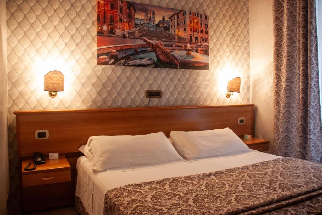 Postel nebo postele na pokoji v ubytování Hotel Assisi