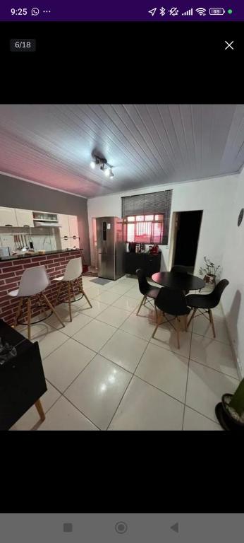 a large living room with a table and chairs at Casa in Brasilia