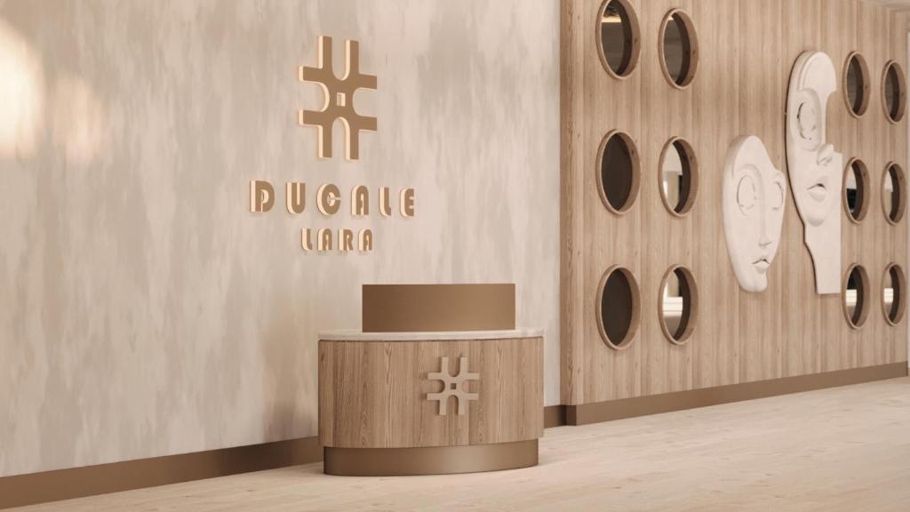 a lobby with a table in front of a wall at Ducale Lara - Ultra All Inclusive in Lara
