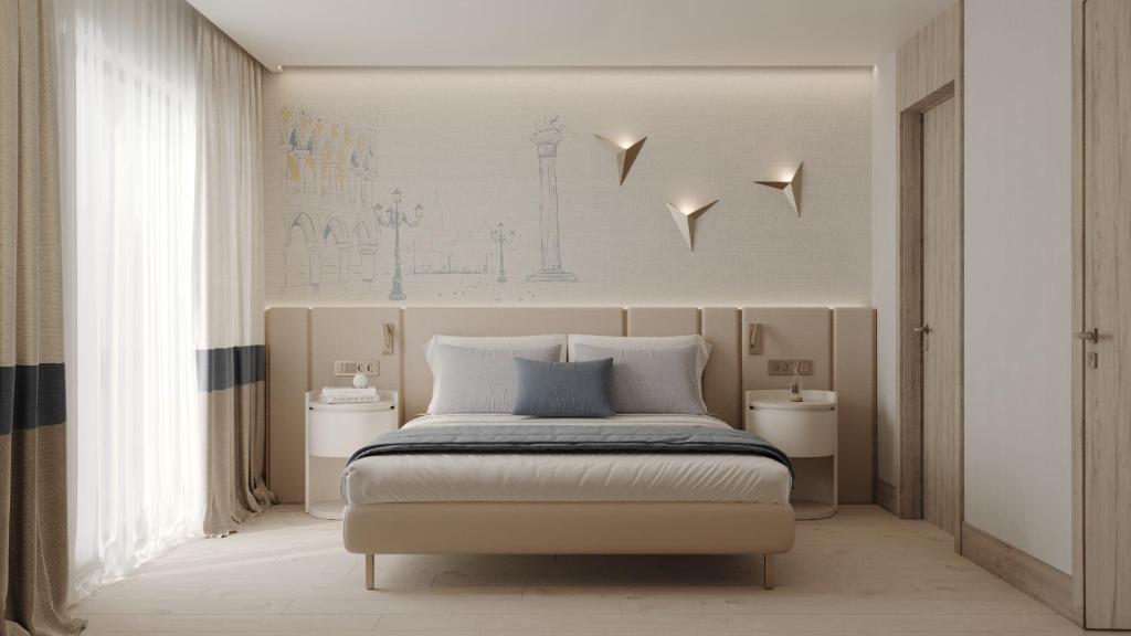 a bedroom with a large bed with two night stands at Ducale Lara - Ultra All Inclusive in Lara