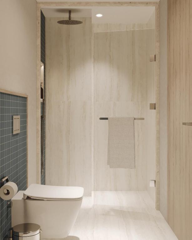 a bathroom with a white toilet and a shower at Ducale Lara - Ultra All Inclusive in Lara