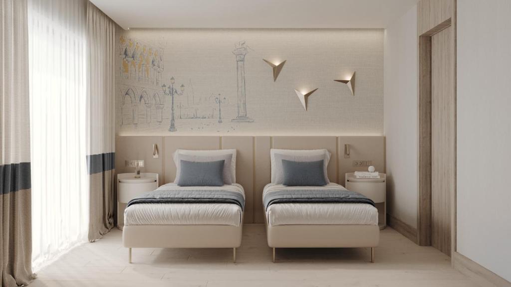 two twin beds in a room with sidx sidx sidx sidx at Ducale Lara - Ultra All Inclusive in Lara