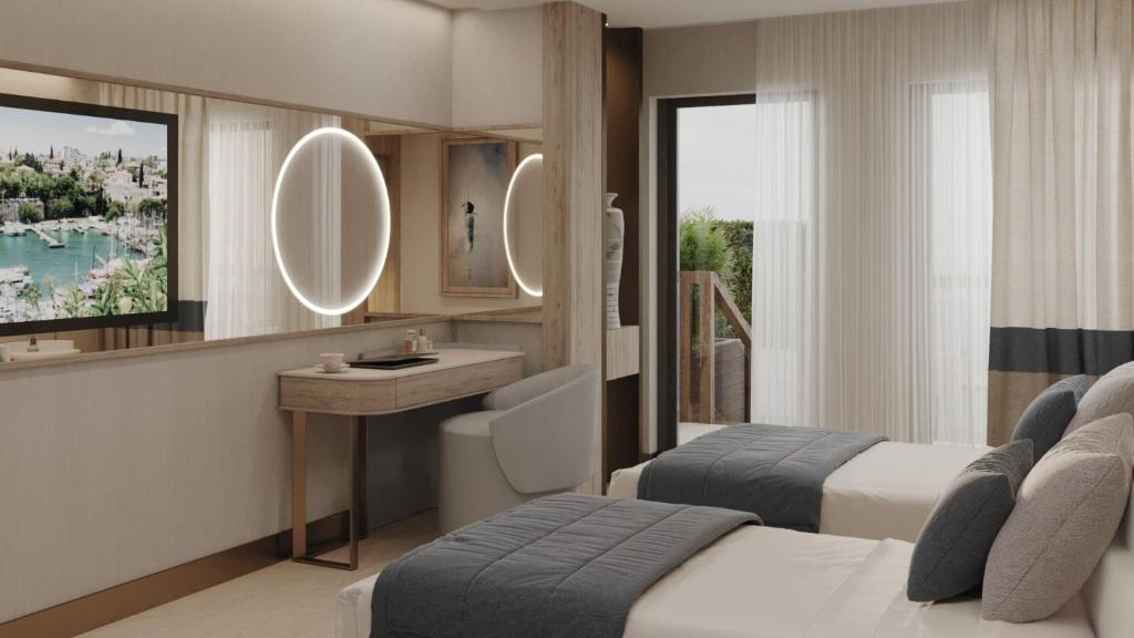 a bedroom with two beds and a sink and a mirror at Ducale Lara - Ultra All Inclusive in Lara