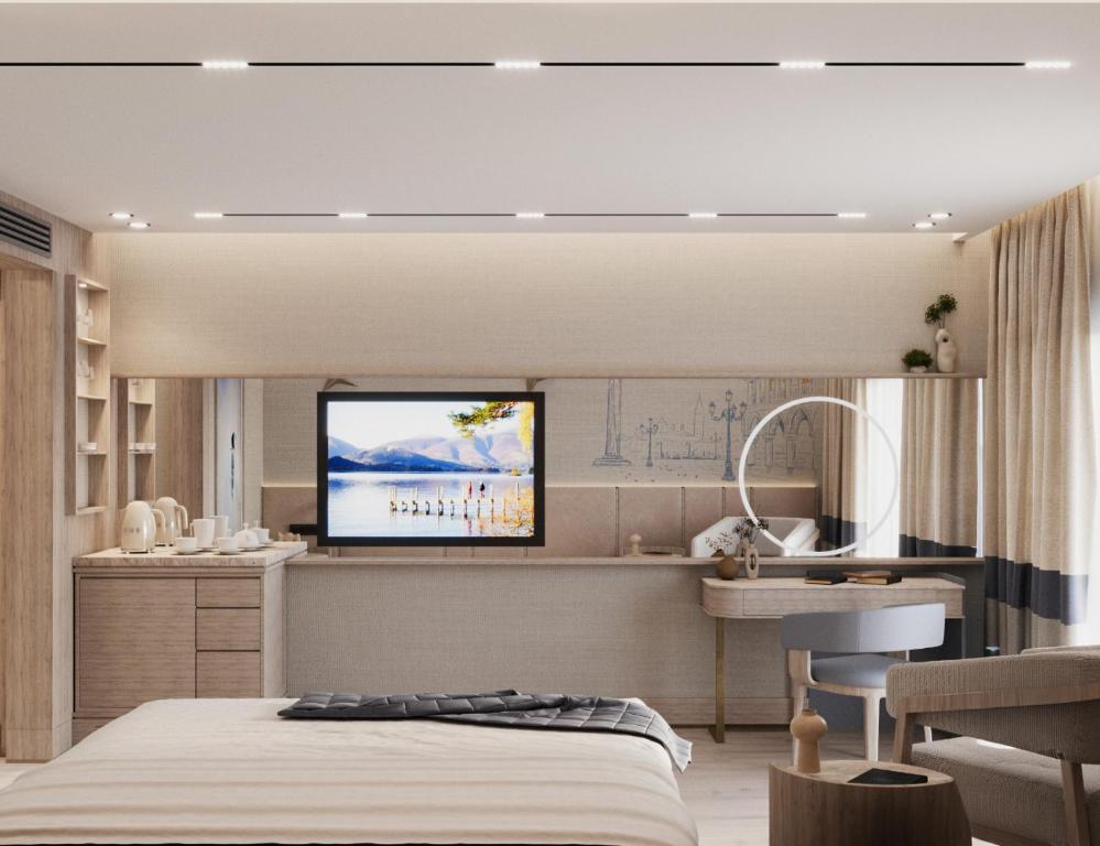 a bedroom with a bed and a kitchen with a tv at Ducale Lara - Ultra All Inclusive in Lara