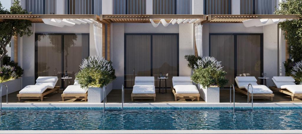 a hotel with a swimming pool and chairs and a building at Ducale Lara - Ultra All Inclusive in Lara