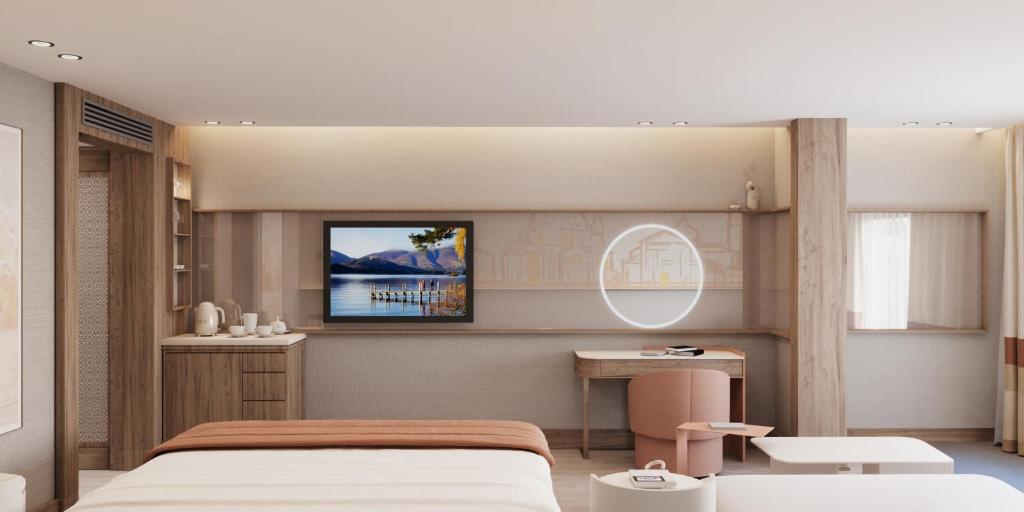a bedroom with a bed and a tv on the wall at Ducale Lara - Ultra All Inclusive in Lara