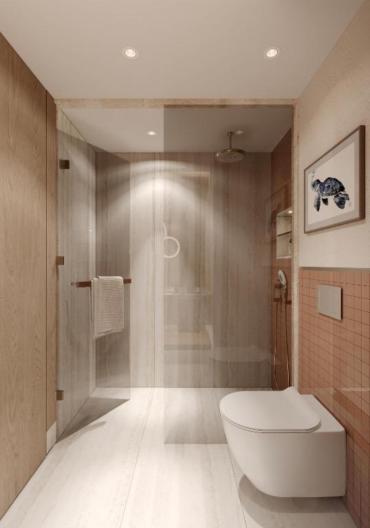 a bathroom with a white toilet and a shower at Ducale Lara - Ultra All Inclusive in Lara
